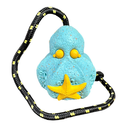 Recycled rubber octopus dog toy in light blue with a yellow starfish and a rope for tugging.